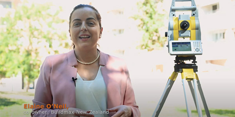 woman standing in front of a total station of GeoMax